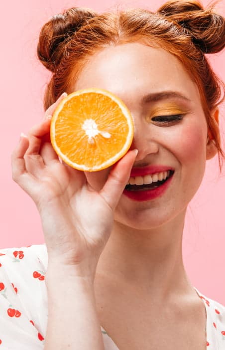 smiling girl holding an orange